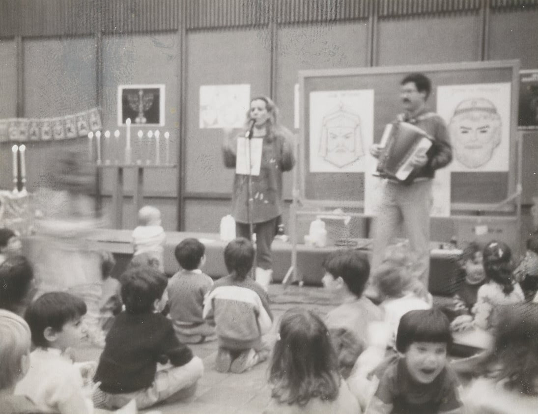 Teachers at the Hillel School in Passaic play and sing Hanukkah songs with the children