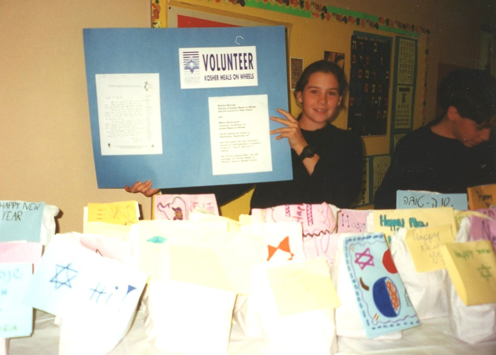 Young volunteer showing poster