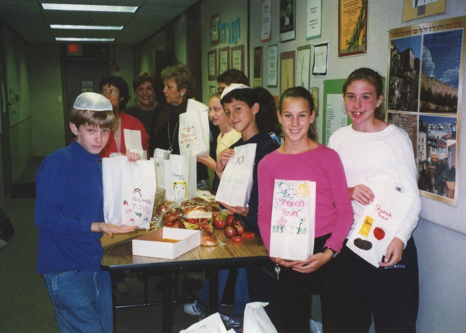 Young volunteers showing goody bags