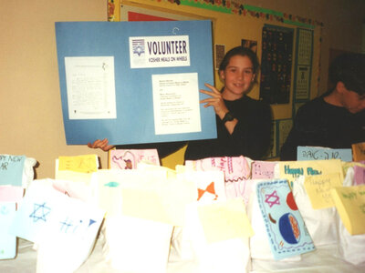 Young volunteer showing poster